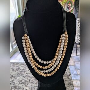 Silver & Gold Four Strand Layered Bead Necklace attached to black cords